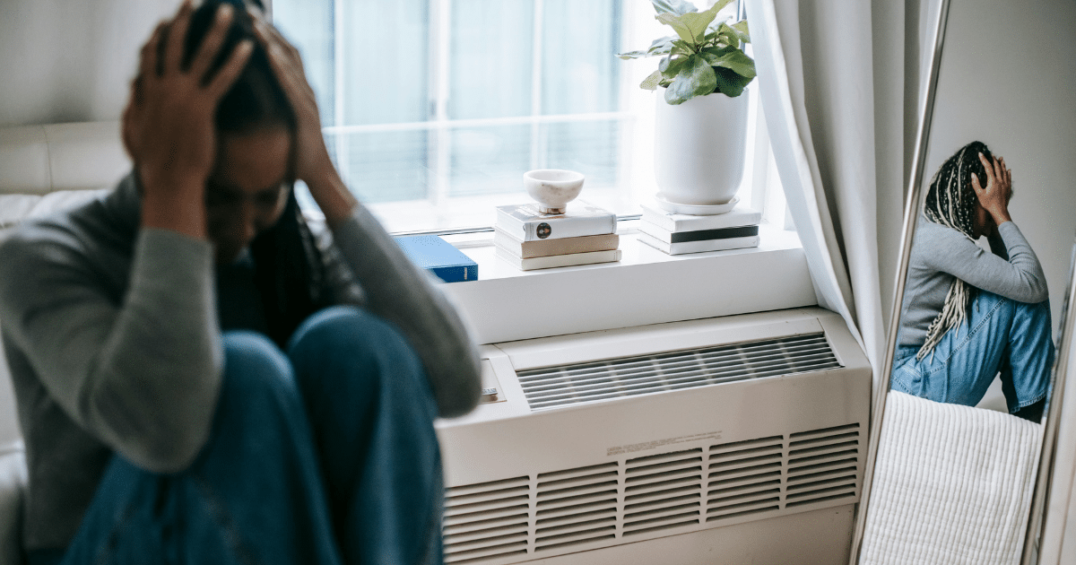 Nicotine effects image: Depressed woman holding head with reflection, illustrating nicotine withdrawal symptoms and duration.