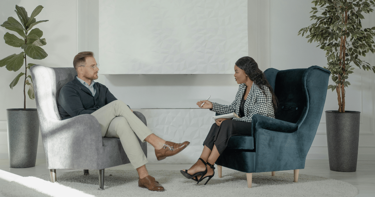 Therapist and patient in session. Mental health counseling for fears and phobias, including megalophobia, in a comfortable office.