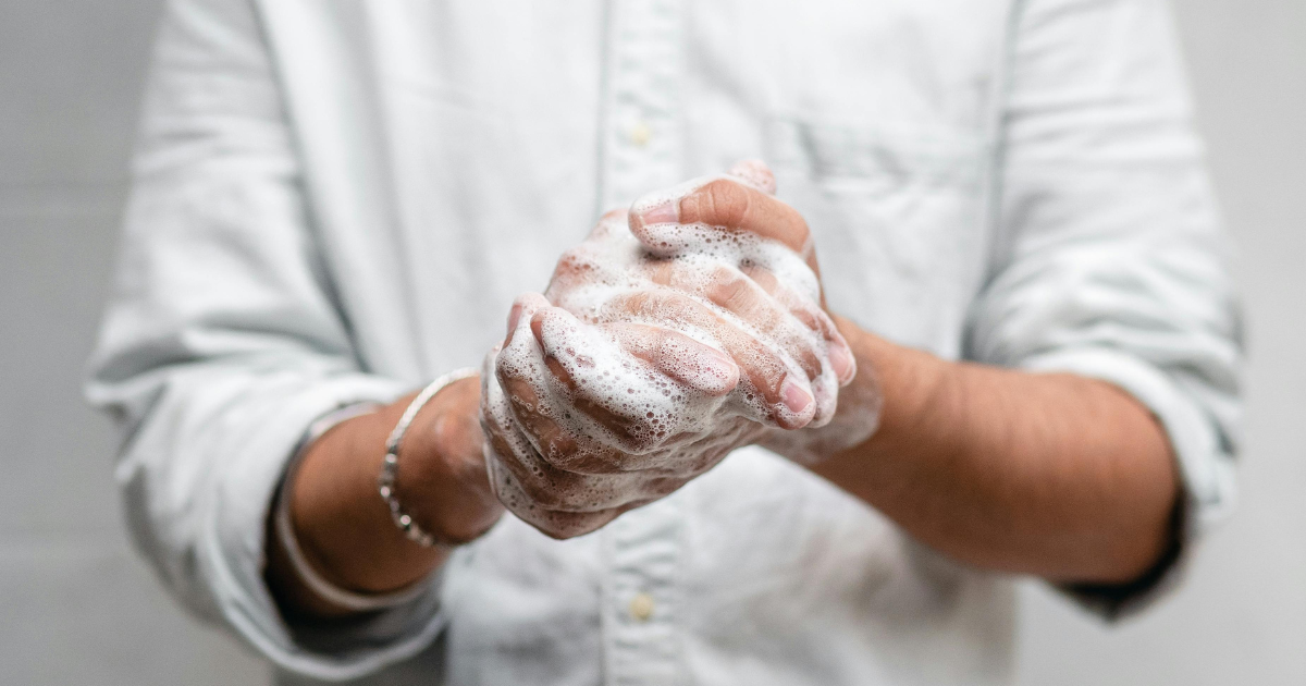 Washing hands thoroughly with soap, a visual representation of OCD tendencies like compulsive handwashing.