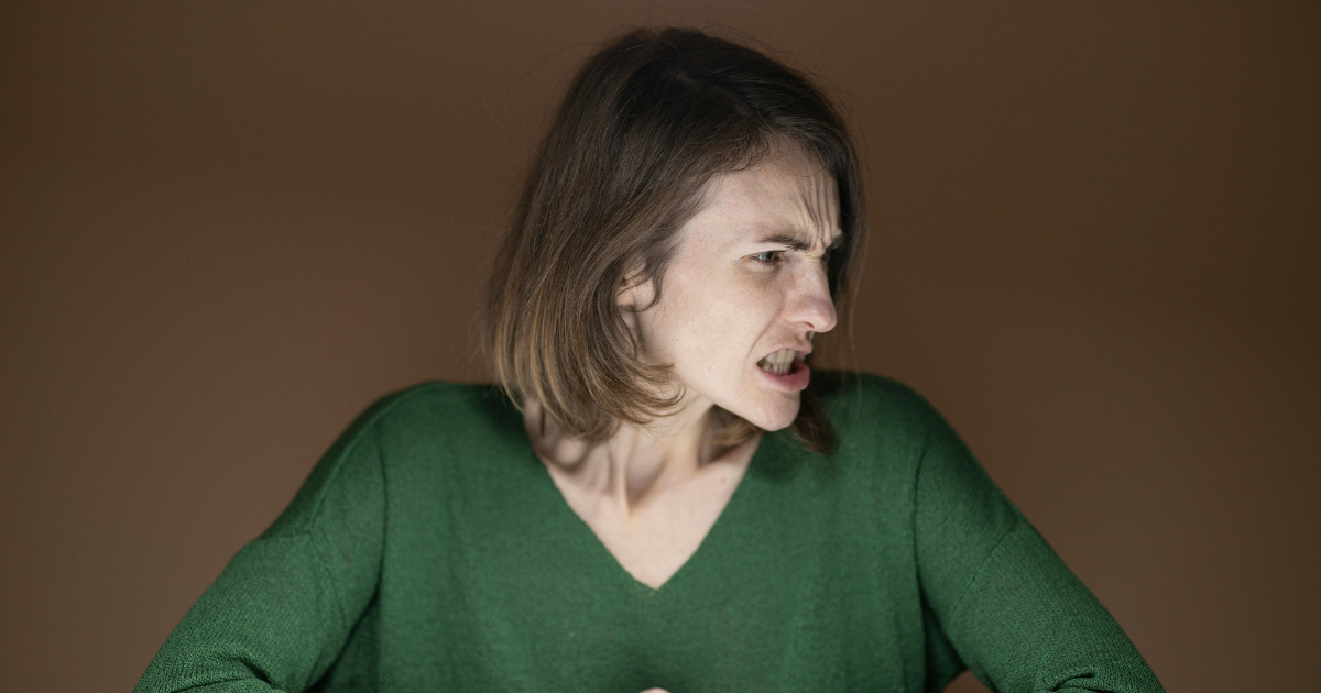 Woman with angry expression, depicting mood swings in bipolar disorder. Ketamine treatment concept.