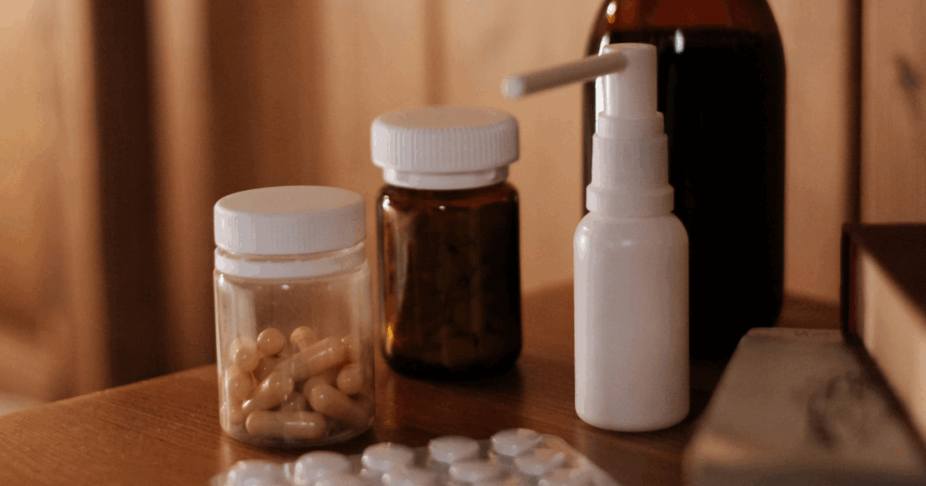 Ketamine nasal spray and capsules, medication bottles on a wooden surface, illustrating duration of effects treatment.