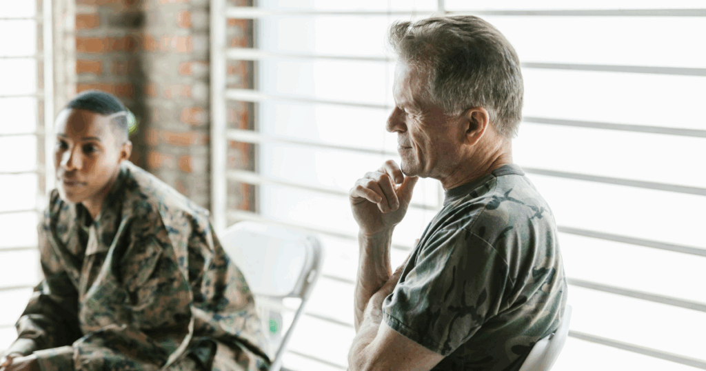 Men in military attire, confronting PTSD symptoms, seeking mental health support and therapy for veterans. 