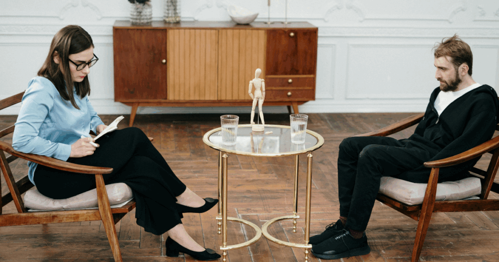 Intensive Outpatient Program: Therapist consulting with patient in a therapy session for enhanced recovery and mental health.